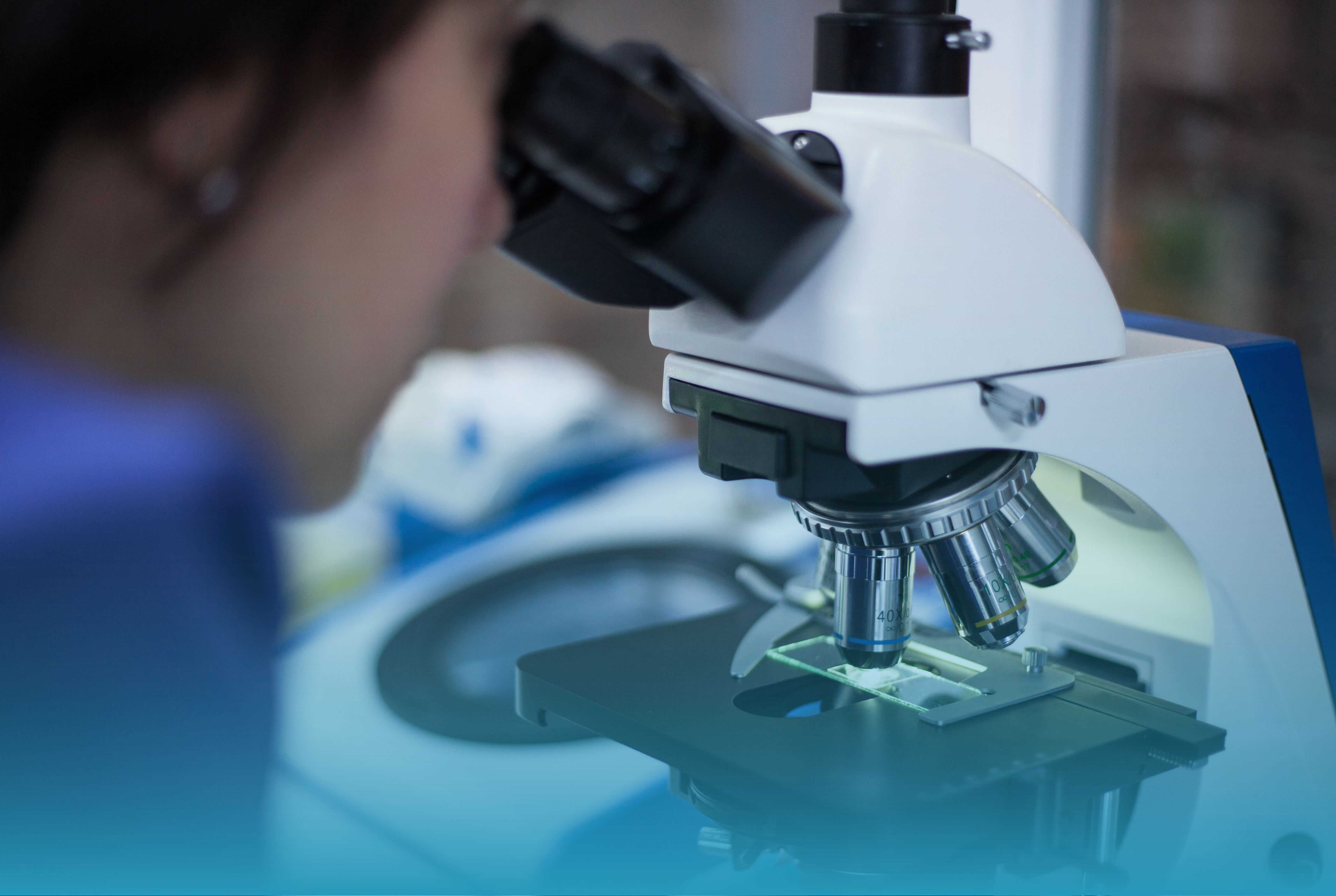 A medical microscope with mathematical graphics in background. 