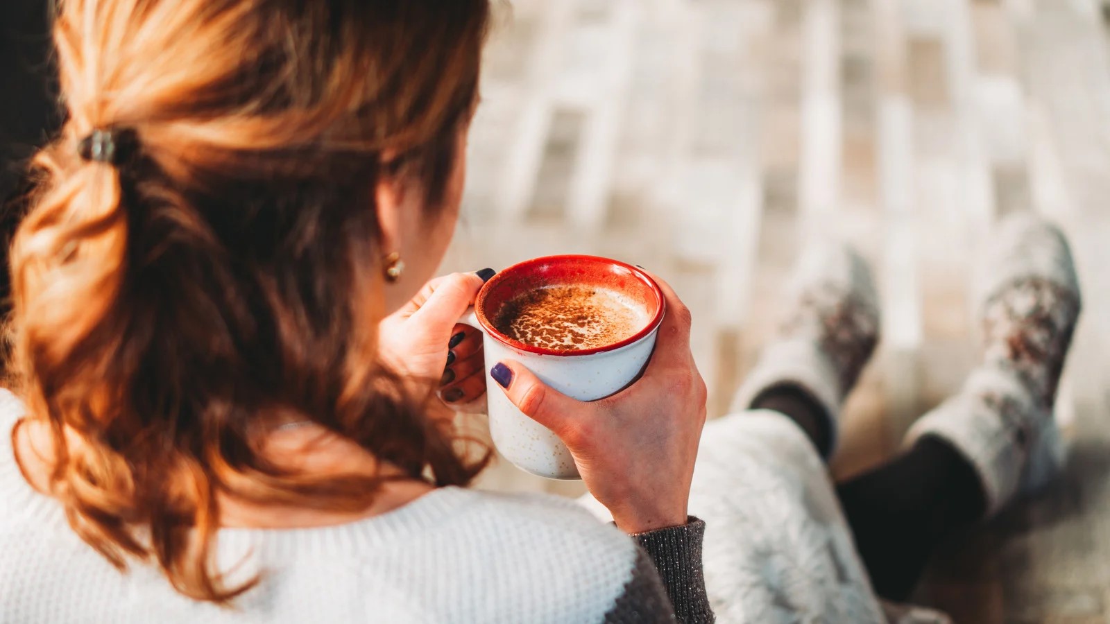 A woman drinking coffee.